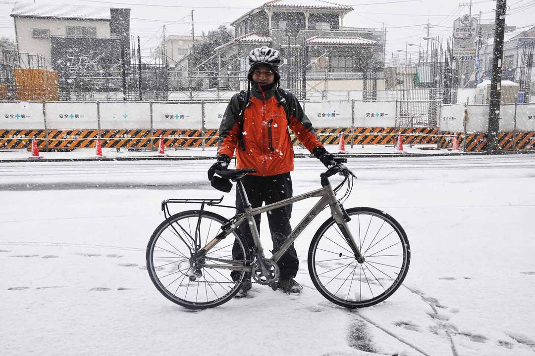 雪の日にクロスバイクで通勤するスタッフ森田とクロスバイクの写真